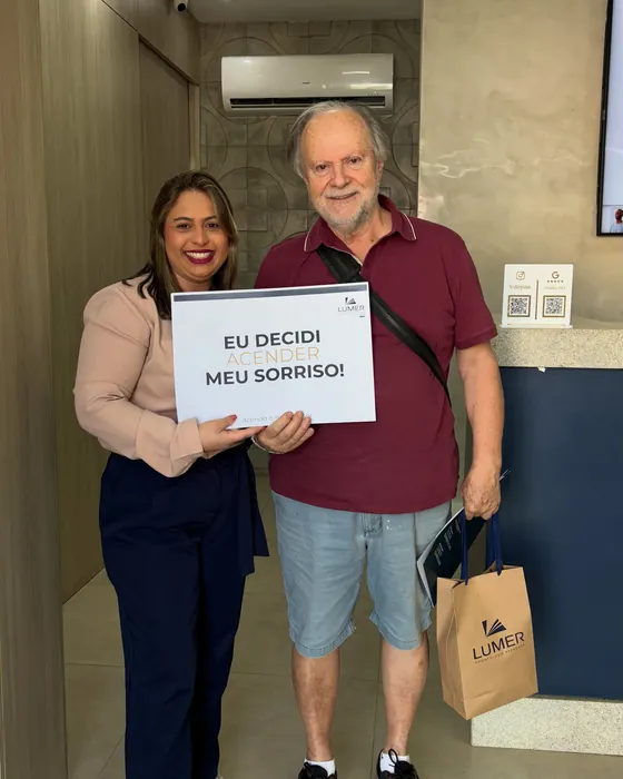 Paciente da Lumer com a placa Eu decidi meu sorriso